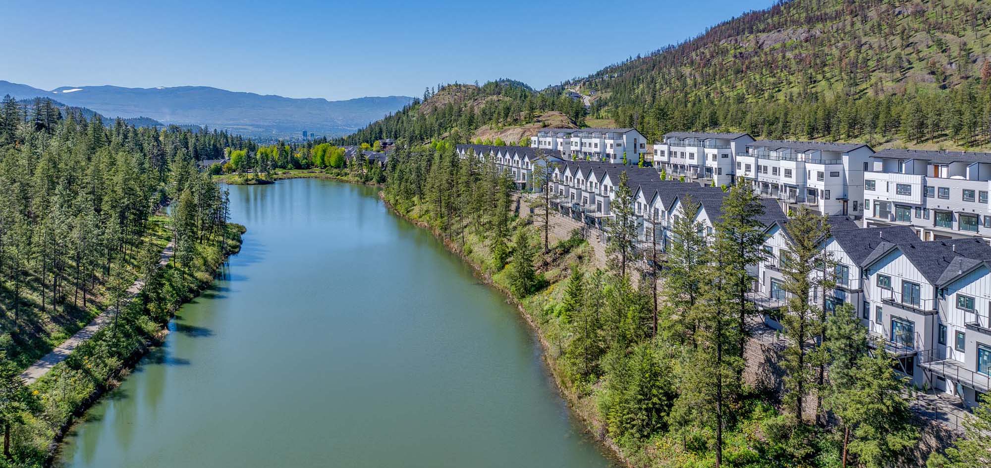 kelowna townhome rows running parallel to still pond and nature in Kelowna