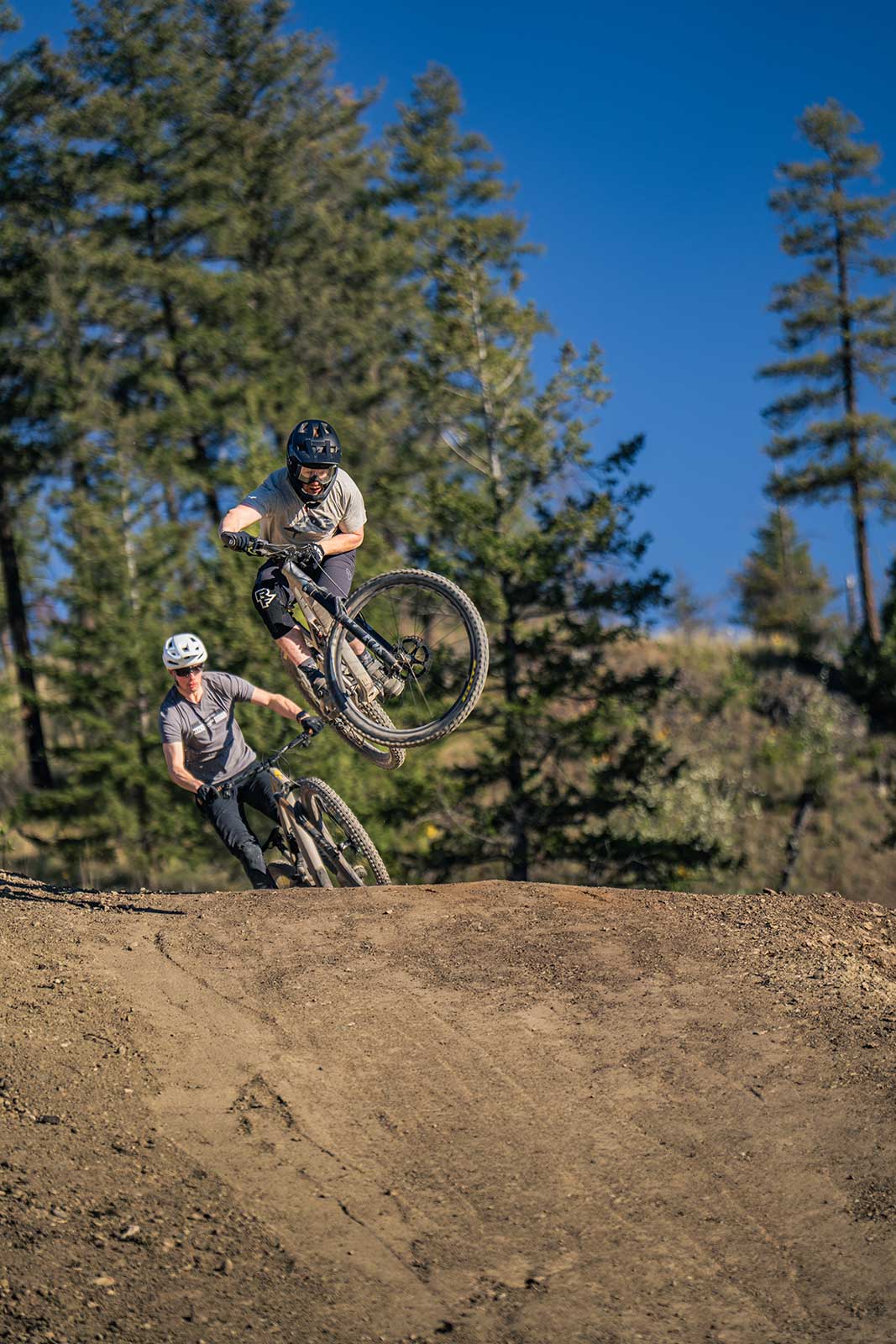 mountain bikers taking a jump on the Wilden trails
